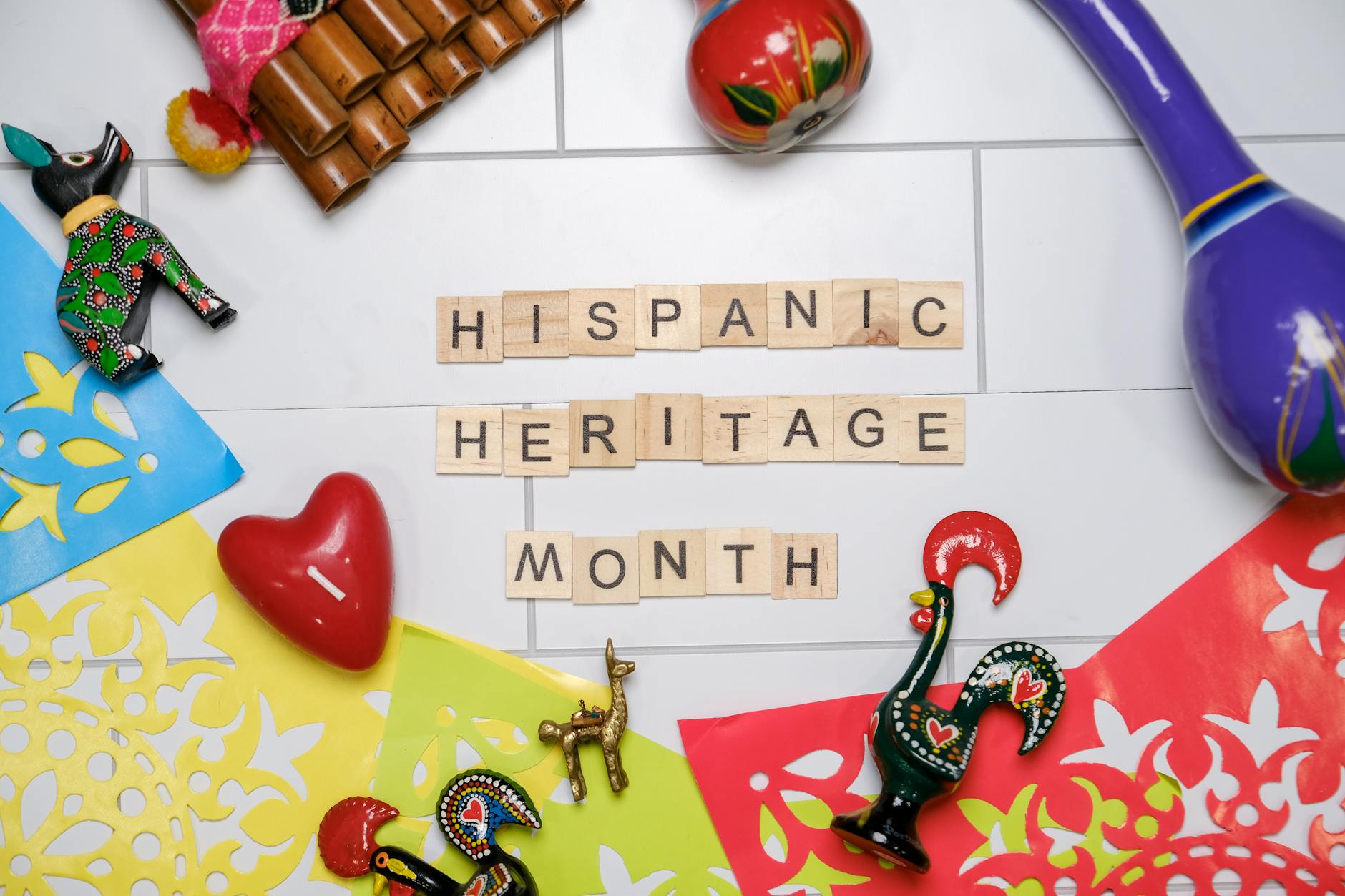 Vibrant Hispanic Heritage Month celebration with cultural artifacts on a colorful background.